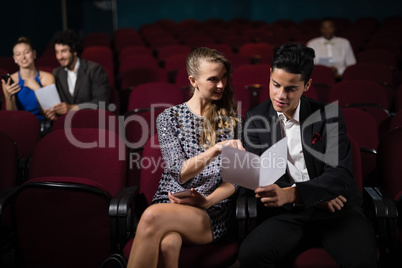 Couple reading in theatre