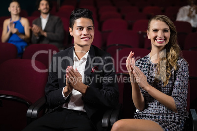 Couple applauding while watching movie