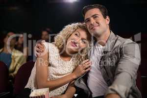 Couple watching movie in theatre