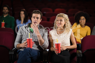Couple watching movie in theatre