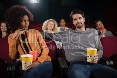 Couple watching movie in theatre