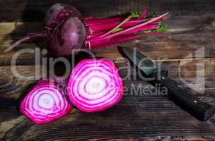 Fresh red beet on a brown wooden background