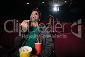 Man watching movie in theatre