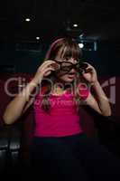 Girl using 3D glasses while watching movie