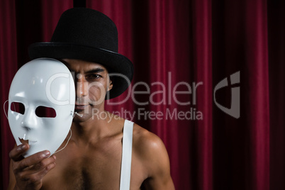 Artist holding white mask