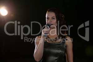 Female singer singing into a microphone