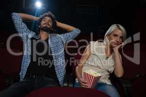 Couple watching a movie in theatre