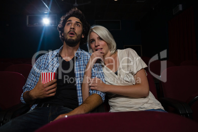 Couple with shocked expression looking at the movie