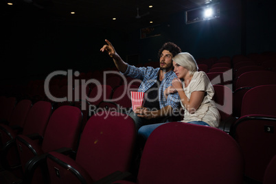 Couple with shocked expression looking at the movie