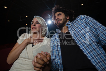 Couple with shocked expression looking at the movie