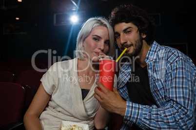 Couple having drinks while watching movie