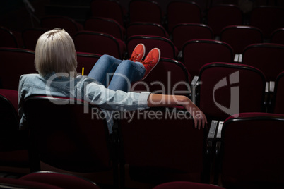 Woman watching movie in theatre Woman watching movie in theatre
