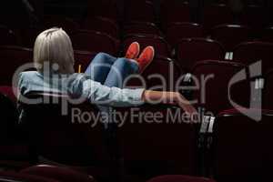 Woman watching movie in theatre