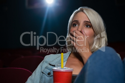 Woman with shocked expression looking at the movie