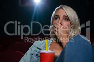 Woman with shocked expression looking at the movie