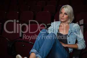 Woman watching movie in theatre