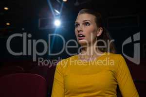 Woman watching movie in theatre