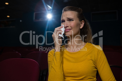 Woman crying while watching movie