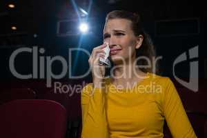 Woman crying while watching movie