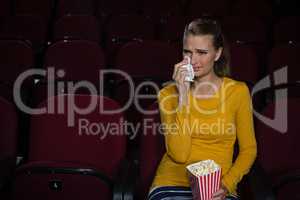 Woman crying while watching movie