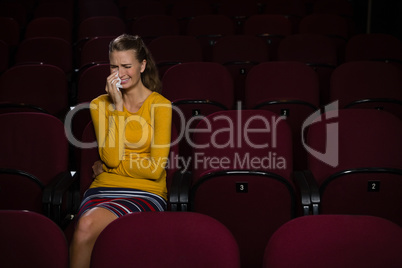 Woman crying while watching movie