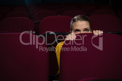 Woman scared while watching movie