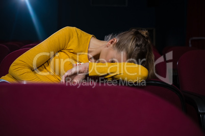 Woman sleeping in a movie theatre