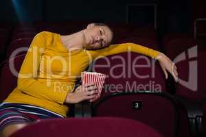 Woman sleeping in a movie theatre