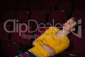 Woman sleeping in a movie theatre