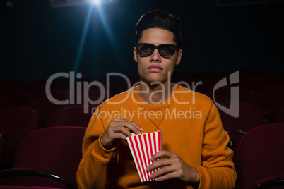 Man having popcorn while watching movie