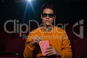 Man having popcorn while watching movie