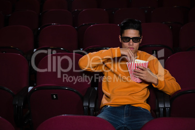 Man having popcorn while watching movie