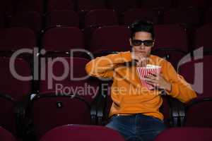 Man having popcorn while watching movie