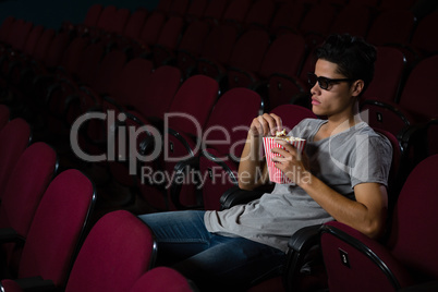 Man having popcorn while watching movie