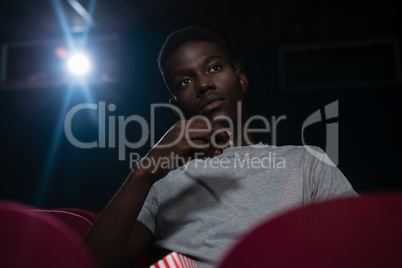 Man having popcorn while watching movie