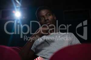 Man having popcorn while watching movie