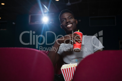 Man having cold drinks while watching movie