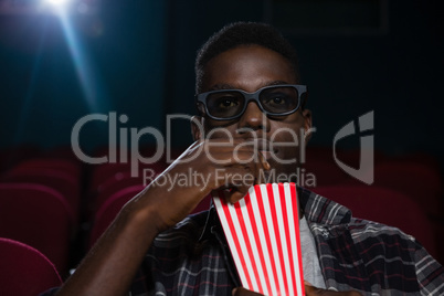 Man having popcorn while watching movie