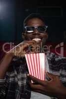 Man having popcorn while watching movie