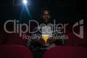 Man having popcorn while watching movie