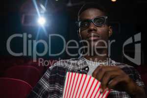 Man having popcorn while watching movie