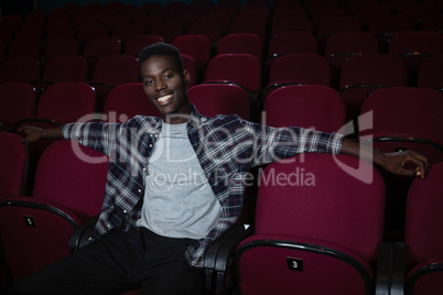 Happy man sitting in theatre