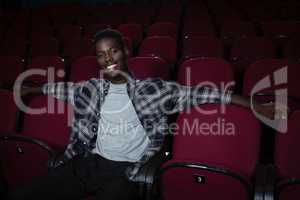 Happy man sitting in theatre