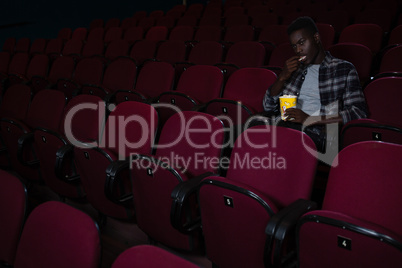 Man having popcorn while watching movie