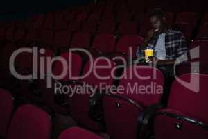 Man having popcorn while watching movie