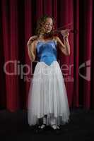 Female artist playing violin on stage