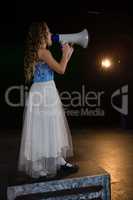 Female artist announcing on megaphone