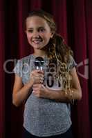 Girl holding microphone on stage
