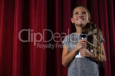 Girl holding microphone on stage