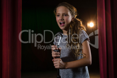Female artist singing song on stage